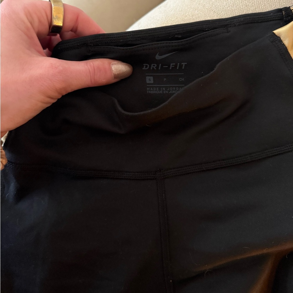 Nike leggings. Black with gold accent down side. Size small leggings